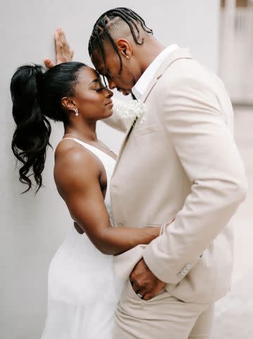 RAETAY PHOTOGRAPHY Simone Biles sharing sweet embrace with husband Jonathan Owens on their wedding day in April 2023.