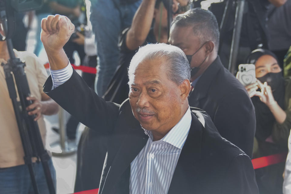 Malaysia's former Prime Minister Muhyiddin Yassin waves as he arrives at courthouse for a corruption charges in Kuala Lumpur, Malaysia, Friday, March 10, 2023. Muhyiddin, who led Malaysia from March 2020 until August 2021, will be the country's second leader to be indicted after leaving office. (AP Photo/Vincent Thian)