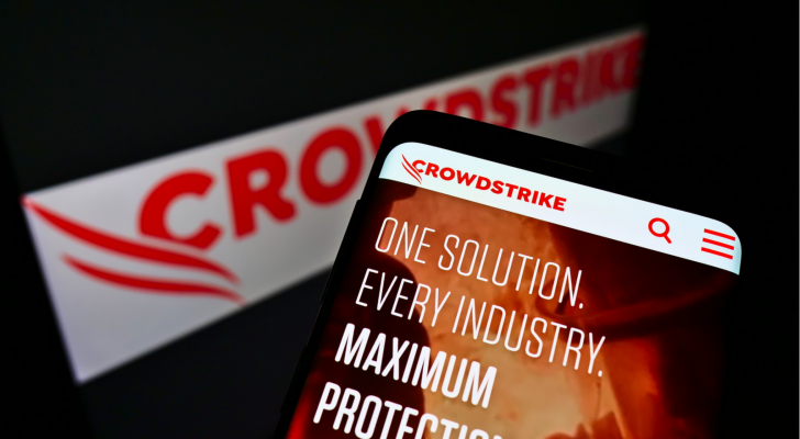 Mobile phone with website of American software company CrowdStrike Holdings (CRWD) Inc. on screen in front of website. Focus on top-center of phone display. Unmodified photo.