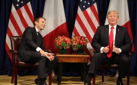 France's president Emmanuel Macron (L) laughs with US President Donald Trump before a meeting at the Palace Hotel during the 72nd session of the United Nations General Assembly on September 18, 2017, in New York - Credit: AFP