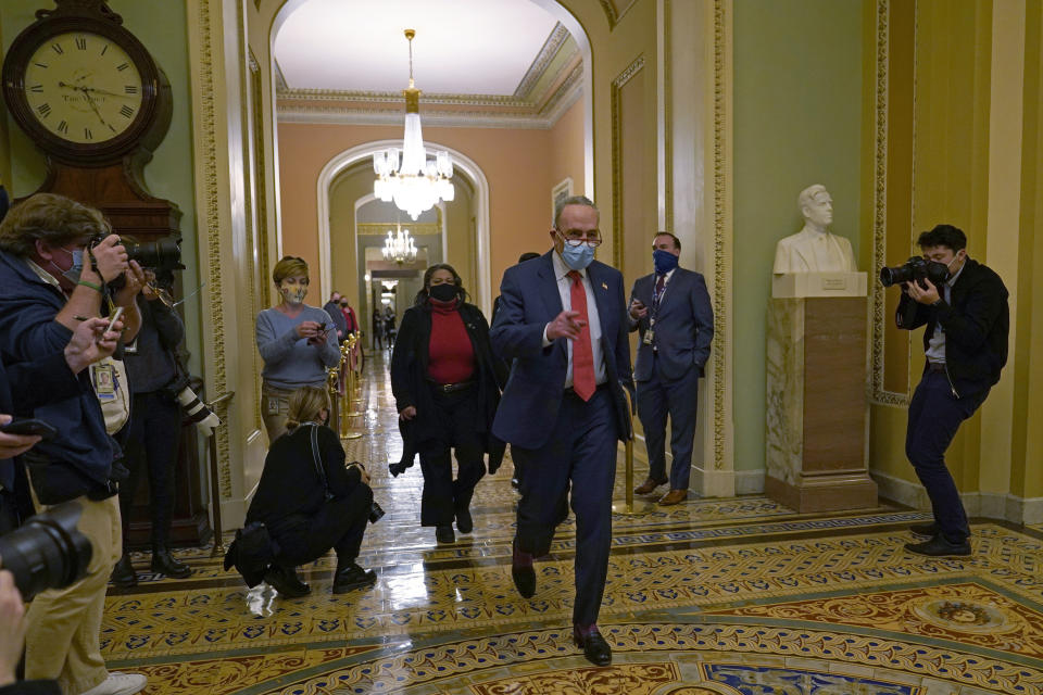 Senate Minority Leader Sen. Chuck Schumer of N.Y., walks past reporters on Capitol Hill in Washington, Tuesday, Dec. 15, 2020. (AP Photo/Susan Walsh)