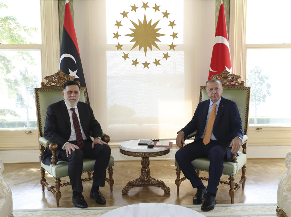 Turkey's President Recep Tayyip Erdogan, right, and Fayez Sarraj, the head of Libya's internationally-recognized government, pose together for photographs prior to their official talks in Istanbul, Sunday, Sept. 6, 2020.(Turkish Presidency via AP. Pool)