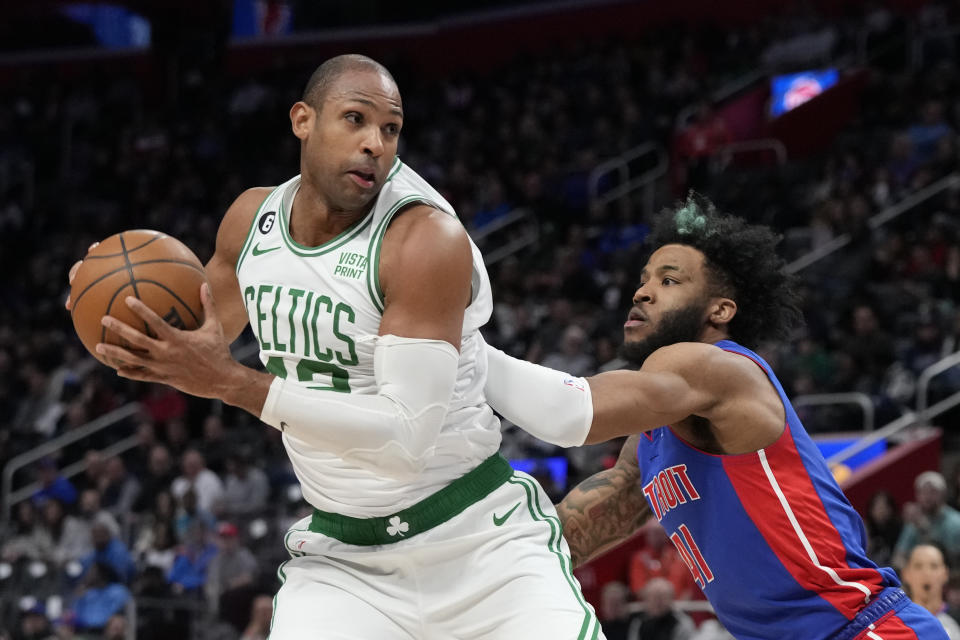 Boston Celtics center Al Horford (42) is defended by Detroit Pistons forward Saddiq Bey (41) during the first half of an NBA basketball game, Monday, Feb. 6, 2023, in Detroit. (AP Photo/Carlos Osorio)