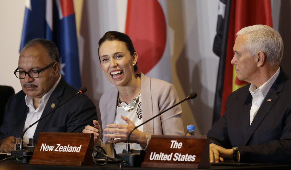 FILE - In this Nov. 18, 2018, file photo, New Zealand Prime Minister Jacinda Ardern, center, gestures beside U.S. Vice President Mike Pence, right, and Papua New Guinea Prime Minister Peter O'Neill during the Leaders Electrification Project meeting as part of the APEC 2018 at Port Moresby, Papua New Guinea. New Zealand on Tuesday, June 30, 2020, canceled its plans to host a major meeting of U.S. and Asian leaders next year because of the coronavirus, opting instead to lead a virtual summit. (AP Photo/Aaron Favila, File)