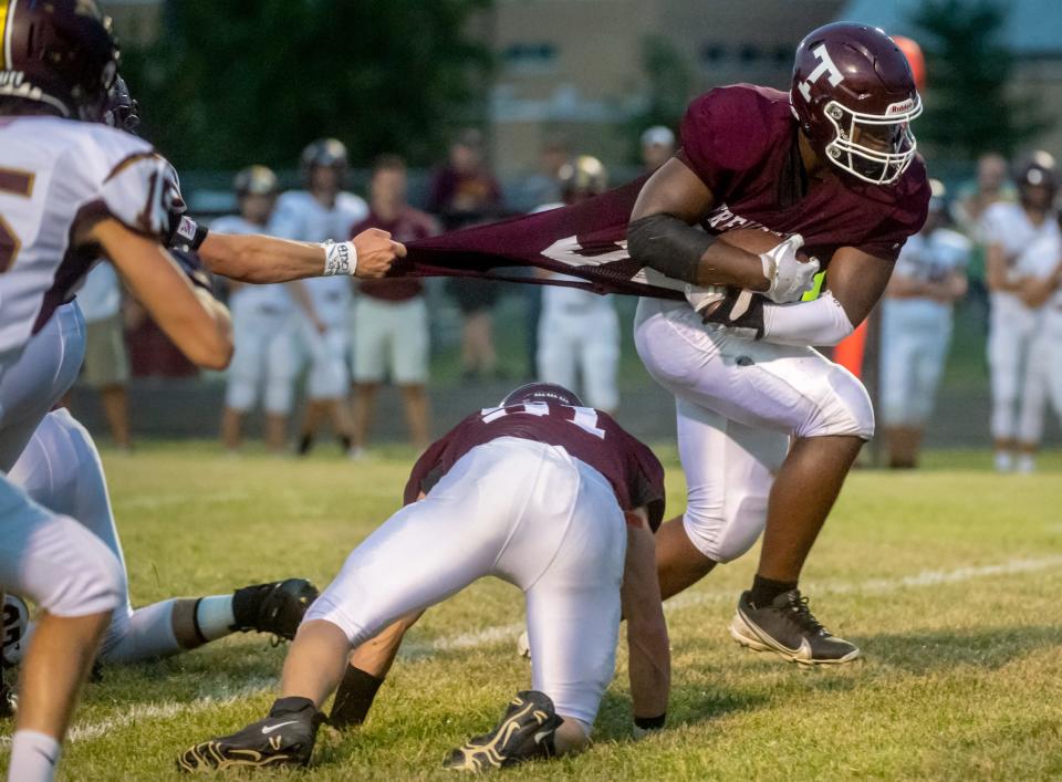 Tremont fullback Shemar Williams pulls away from a LeRoy defender who has a hold of his jersey in the first half Friday, Sept. 10, 2021 in Tremont. The Turks defeated LeRoy 42-12.