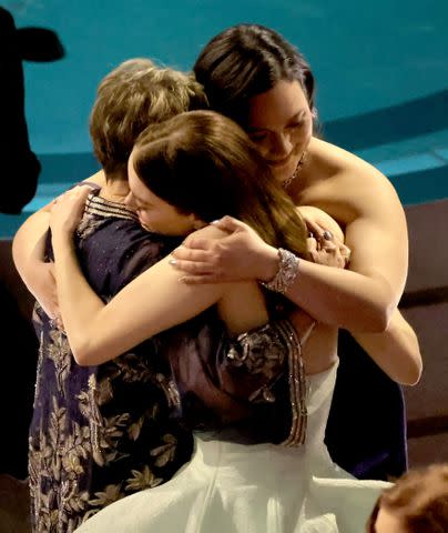 <p>Kevin Winter/Getty</p> Annette Bening, Emma Stone, and Lily Gladstone embrace in the audience during the 96th annual Academy Awards.