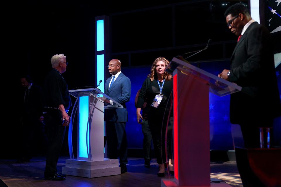 Sen. Raphael Warnock (D-Ga.) and Georgia Republican Senate candidate Herschel Walker are seen prior to the Nexstar Georgia Senate Debate at District Live at Plant Riverside District in Savannah, Ga., on Friday, October 14, 2022.