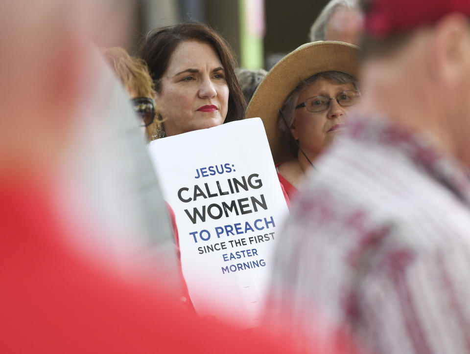 FILE - In this Tuesday, June 11, 2019 file photo, Janene Cates Putman of Athens, Tenn., holds a sign during a demonstration outside the Southern Baptist Convention's annual meeting in Birmingham, Ala. Among the millions of women belonging to churches of the Southern Baptist Convention, there are many who have questioned the faith’s gender-role doctrine and more recently urged a stronger response to disclosures of sexual abuse perpetrated by SBC clergy. (AP Photo/Julie Bennett)