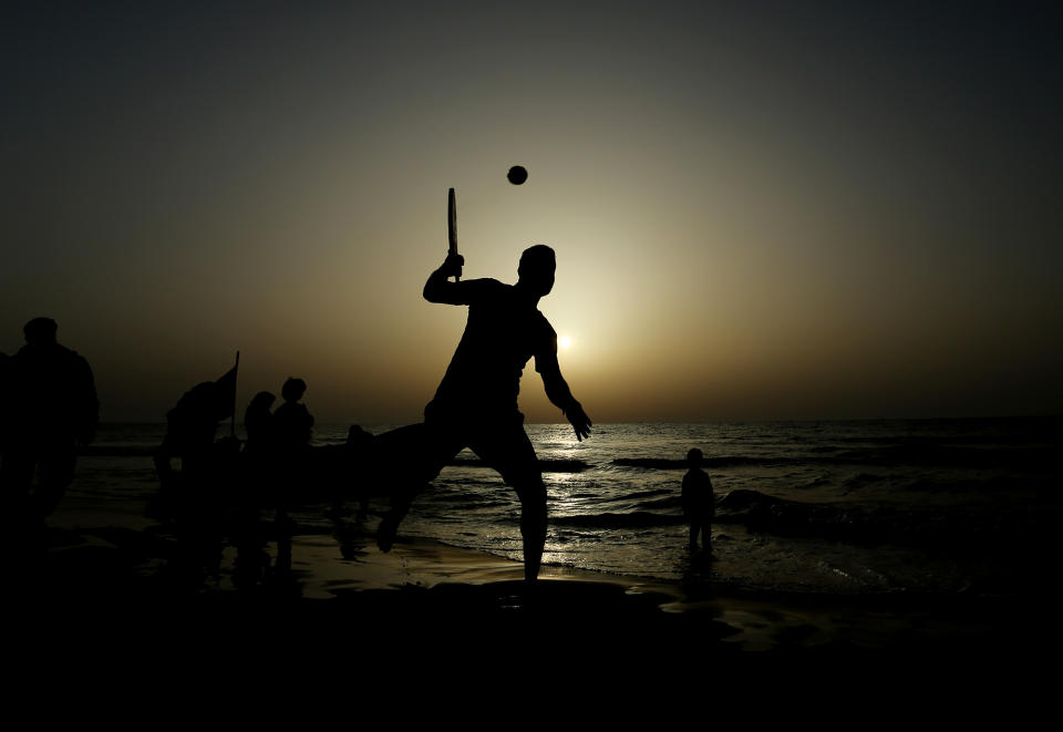 <p>Palestinians spend their time at the beach at sunset in Gaza City.</p>
