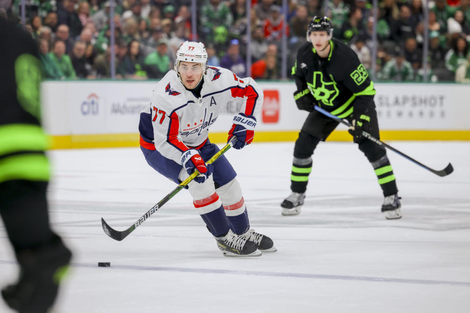 Washington Capitals right wing T.J. Oshie (77) steals the puck away from Dallas Stars defenseman Esa Lindell (23) during the first period of an NHL hockey game, Saturday, Jan. 27, 2024, in Dallas. (AP Photo/Gareth Patterson)