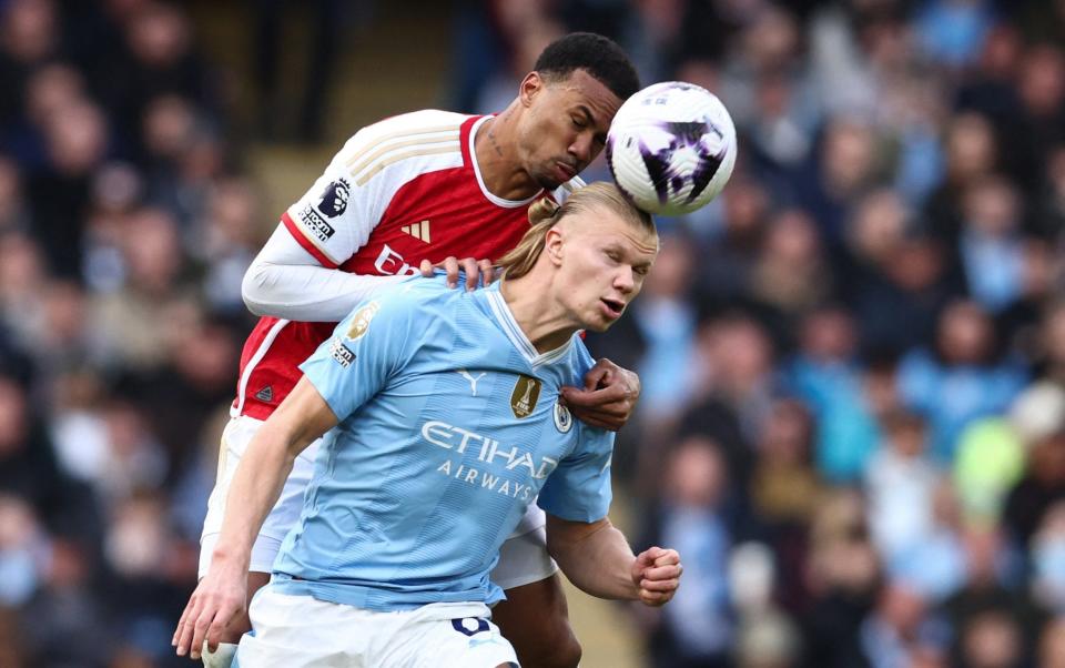 Arsenal's Brazilian defender #06 Gabriel Magalhaes (L) fights for the ball with Manchester City's Norwegian striker #09 Erling Haaland during the English Premier League football match between Manchester City and Arsenal at the Etihad Stadium in Manchester, north west England, on March 31, 2024