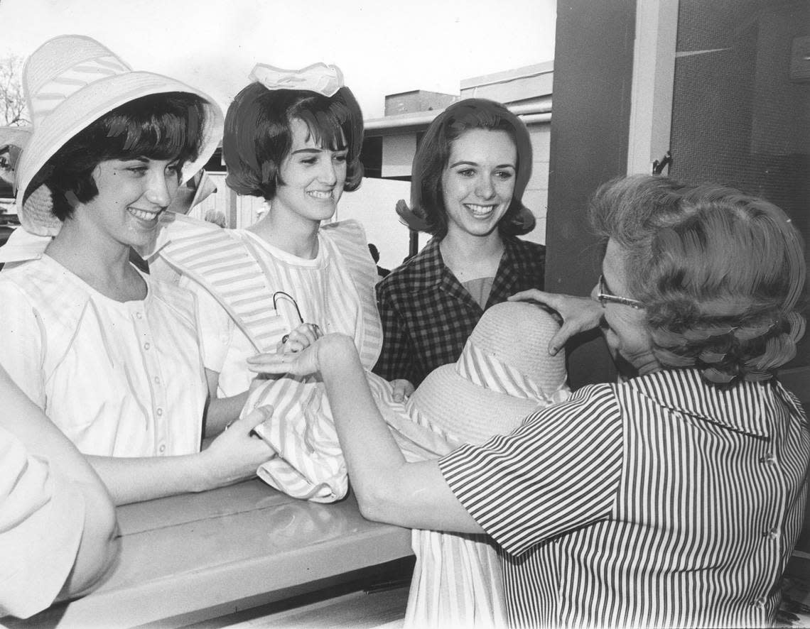April 12, 1965: Margaret Carriher of Fort Worth, Becky Martin of Arlington and Janice Johnson of Fort Worth receiving their Six Flags Over Texas uniforms