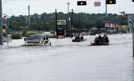 Flood waters from Hurricane Harvey cover the main street in Dickinson, Texas August 27, 2017. REUTERS/Rick Wilking