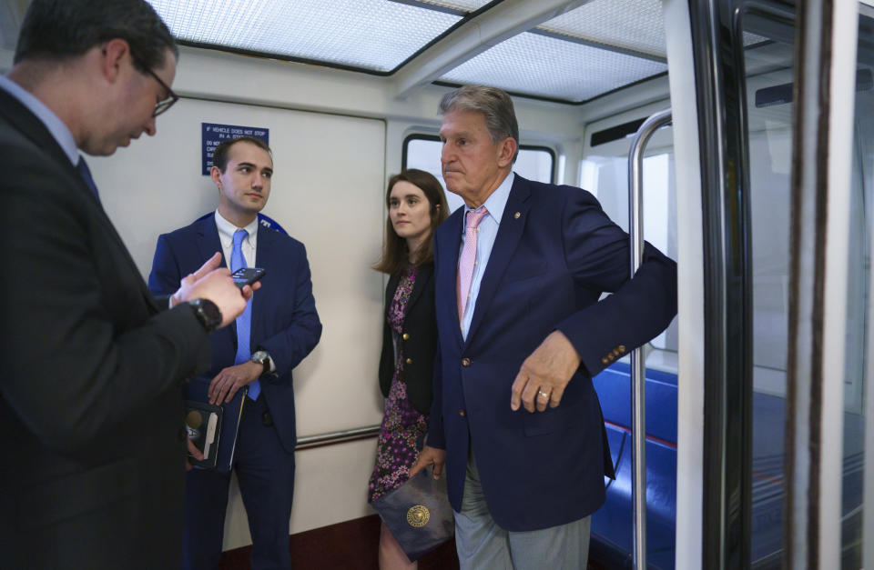 Sen. Joe Manchin, D-W.Va., a key infrastructure negotiator, talks to his staff on the Senate subway after working behind closed doors with other Democrats in a basement room at the Capitol in Washington, Wednesday, June 16, 2021. (AP Photo/J. Scott Applewhite)
