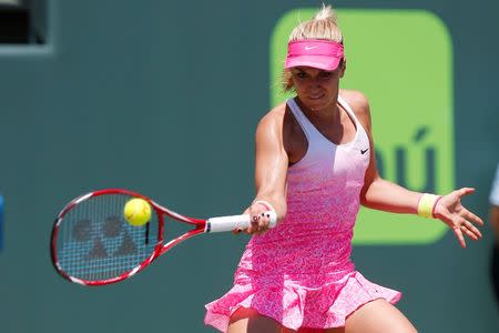 Sabine Lisicki hits a forehand against Serena Williams (not pictured) on day ten of the Miami Open at Crandon Park Tennis Center. Williams won 7-6 (4), 1-6, 6-3. Mandatory Credit: Geoff Burke-USA TODAY Sports