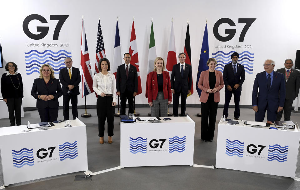 G7 Foreign and Development Ministers pose for a group photo in Liverpool, England Sunday, Dec. 12, 2021. Foreign Secretary Liz Truss is hosting U.S. Secretary of State Antony Blinken and other Group of Seven counterparts for weekend talks in the northwest England port city of Liverpool as the wealthy nations club faces growing tensions with Russia, China and Iran. From left, Italy's Deputy Minister of Foreign Affairs Marina Sereni, German Federal Minister for Economic Cooperation and Development Svenja Schulze, Phillippines Secretary of Foreign Affairs Teodoro L Locsin Jr, Germany's Foreign Minister Annalena Baerbock, Italy's Foreign Minister Luigi Di Maio, Britain's Foreign Secretary Liz Truss, US Secretary of State Antony Blinken, Canada's Minister of Foreign Affairs Melanie Joly, Canada's Minister of International Development Harjit Sajjan, High Representative of the Union for Foreign Affairs Josep Borrell and Brunei Darussalam's Minister of Foreign Affairs Dato Erywan Pehin Yusof. (Olivier Douliery/Pool via AP)