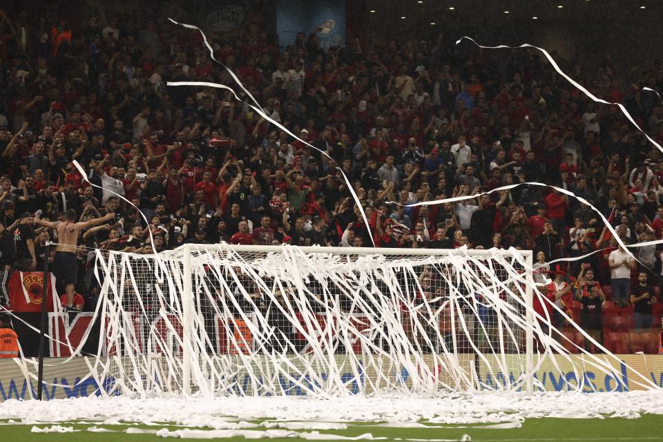 The goal post is covered with papers thrown by Albanian fans prior the start of the UEFA Nations League soccer match between Albania and Israel at Air Albania stadium in Tirana, Albanian, on Friday, June 10, 2022. (AP Photo/Franc Zhurda)