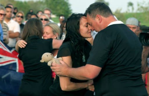 The father (right) and mother (second left) of the New Zealand triplets who perished in a blaze at a Qatar shopping mall are consoled during a gathering held nearby on May 29. Firefighters in Qatar told Wednesday how they tried to rescue 13 children trapped by the blaze but by the time they reached the toddlers most were dead, huddled in the arms of two fellow firemen who also perished