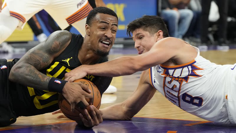 Utah Jazz forward John Collins and Phoenix Suns guard Grayson Allen scramble for the ball during game Saturday, Oct. 28, 2023, in Phoenix. 