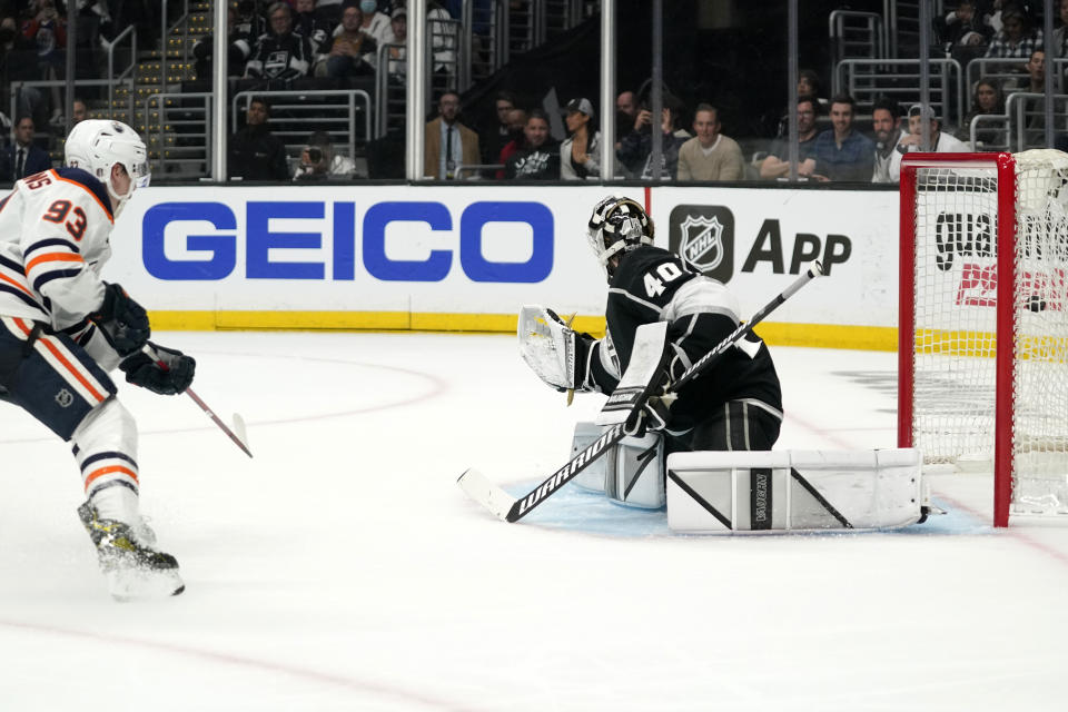 Edmonton Oilers center Ryan Nugent-Hopkins, left, scores on Los Angeles Kings goaltender Cal Petersen during the third period in Game 3 of an NHL hockey Stanley Cup first-round playoff series Friday, May 6, 2022, in Los Angeles. (AP Photo/Mark J. Terrill)