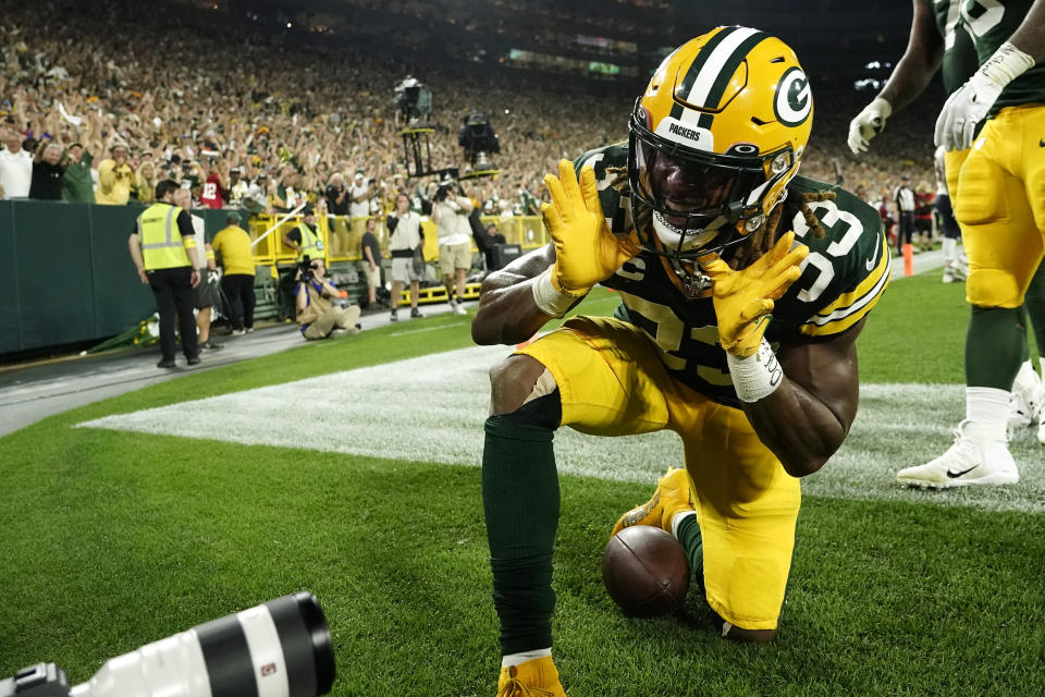 Green Bay Packers running back Aaron Jones (33) celebrates after catching an 8-yard touchdown pass during the first half of an NFL football game against the Chicago Bears Sunday, Sept. 18, 2022, in Green Bay, Wis. (AP Photo/Morry Gash)