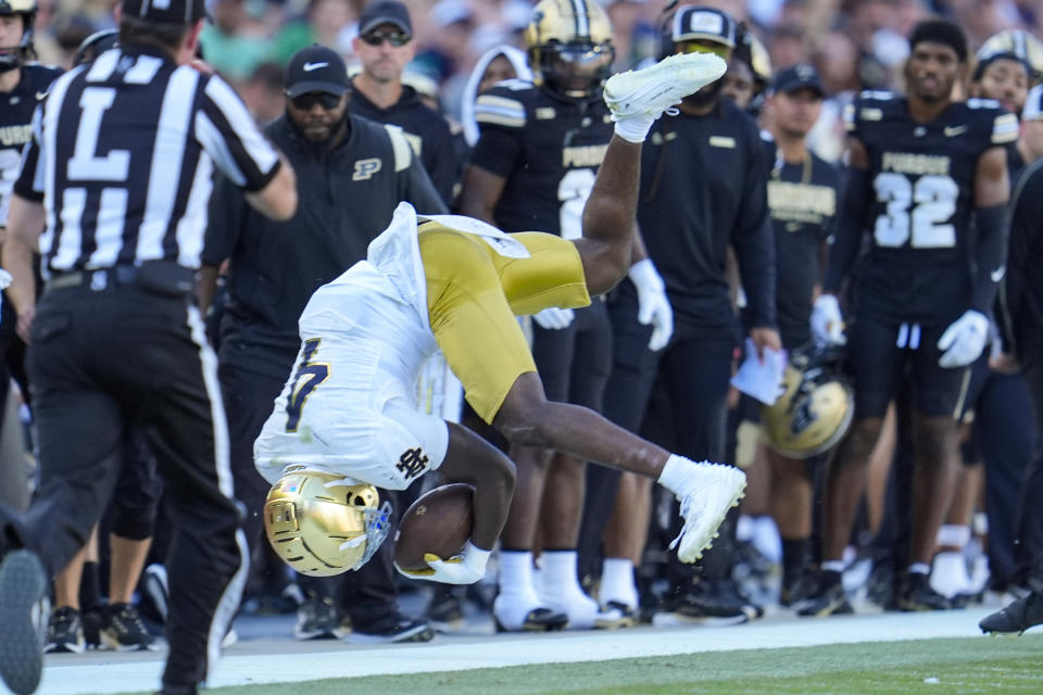 Notre Dame running back Jeremiyah Love (4) flips after being tackled during the second half of an NCAA college football game against Purdue in West Lafayette, Ind., Saturday, Sept. 14, 2024. (AP Photo/Michael Conroy)