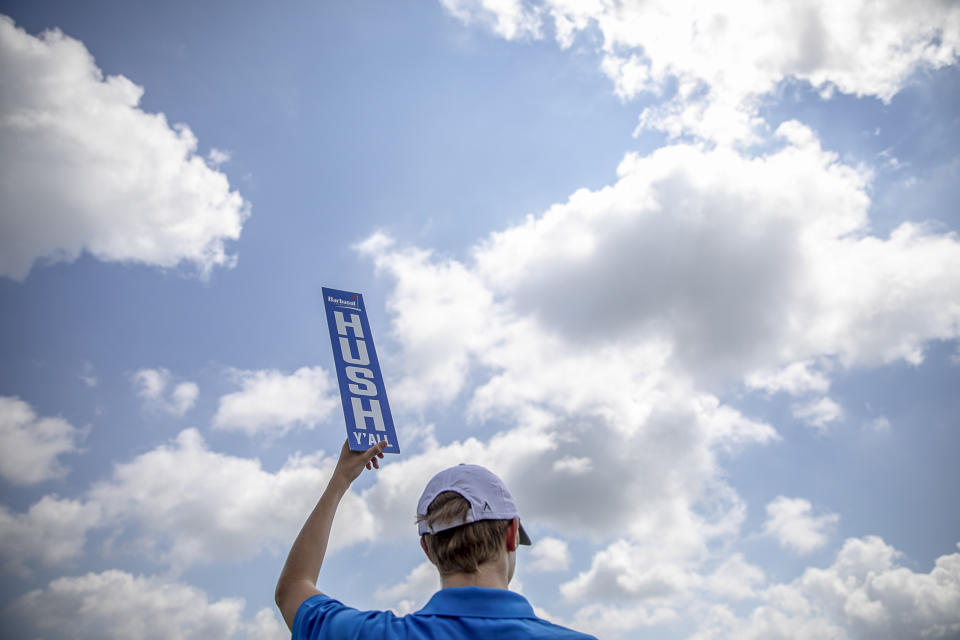 Jack Ackermann, of Lexington, Ky., holds a, "Hush, Y'all" sign at the 18th green during the second round of the Barbasol Championship golf tournament at Keene Trace Golf Club in Nicholasville, Ky., Friday, July 19, 2019. (Ryan C. Hermens/Lexington Herald-Leader via AP)