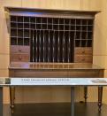 A merchant's desk, built about 1855, is shown in the atrium of the Abraham Lincoln Presidential Library on Thursday, Sept. 16, 2021 in Springfield, Ill.. The desk that Abraham Lincoln used to draft the presidential inaugural address he delivered on March 4, 1861, on the eve of the Civil War, is on display free to the public. Lincoln needed a quiet place away from well-wishers to write the speech, and his brother-in-law, Clark Moulton Smith, offered him a third-floor storage room in the store he owned on the state Capitol square in downtown Springfield. The state purchased the desk from the Smith family in 1953 and this summer spent $6,300 to have it historically restored and repaired. (AP Photo/John O'Connor)