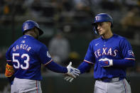 Texas Rangers' Corey Seager, right, celebrates with Adolis García, right, after hitting a three-run home run against the Oakland Athletics during the eighth inning of a baseball game Monday, May 6, 2024, in Oakland, Calif. (AP Photo/Godofredo A. Vásquez)