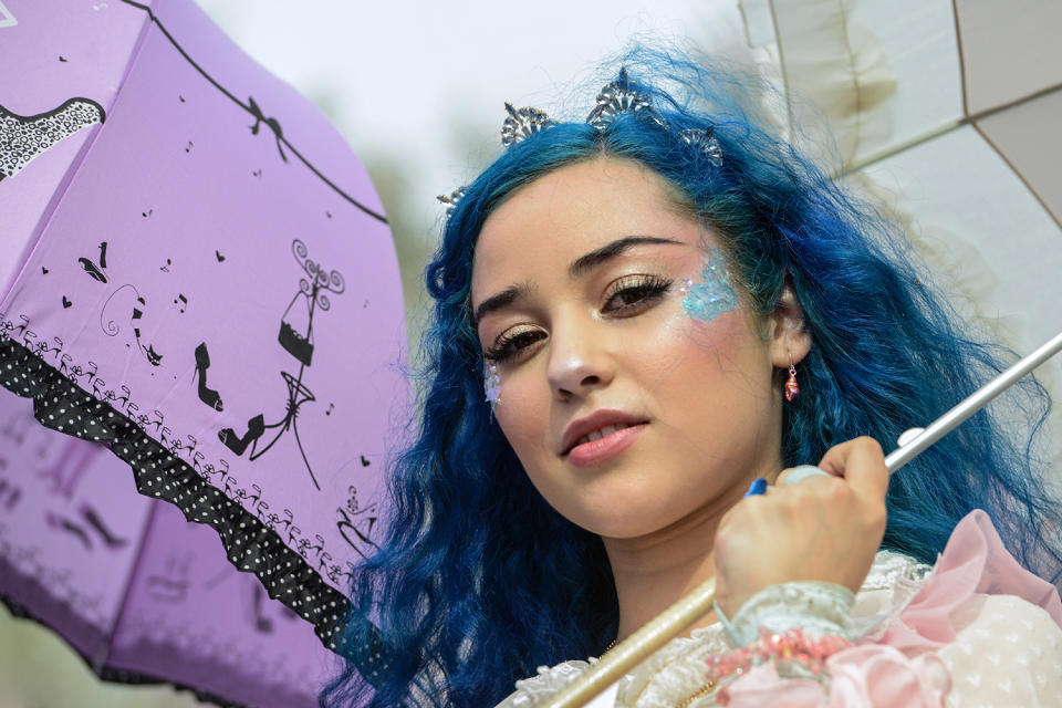 Woman holding parisol at Lolita-style fashion show