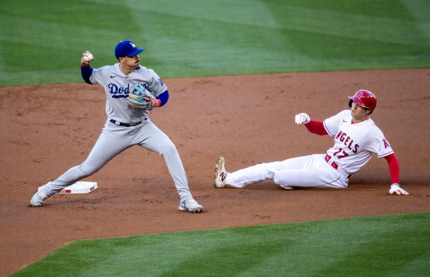 Anaheim, CA - June 21: Dodgers second baseman Miguel Vargas looks to first as Angels starting pitcher Shohei Ohtani is out while sliding into second base on Mike Trout's single at Angel Stadium in Anaheim Wednesday, June 21, 2023. (Allen J. Schaben / Los Angeles Times)