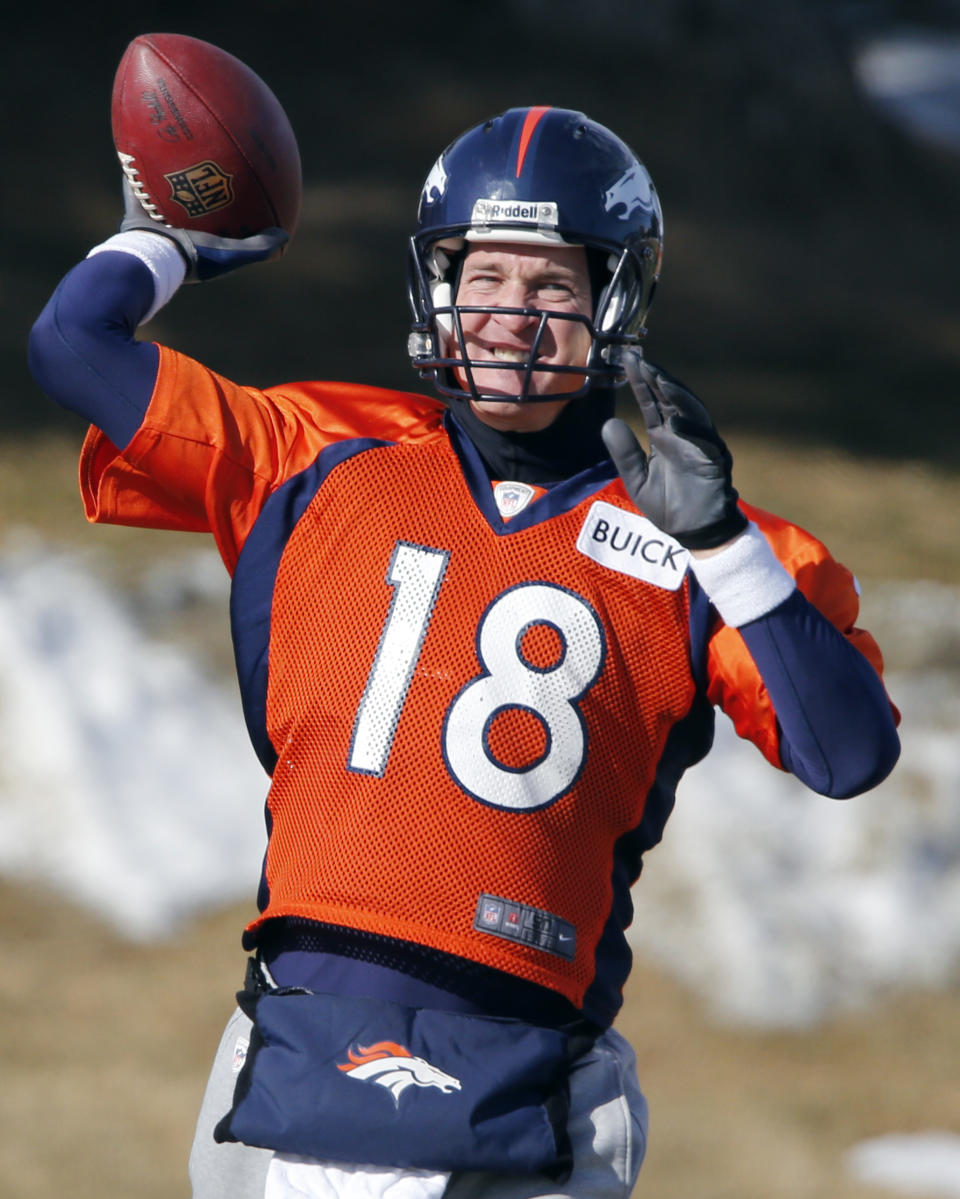 Denver Broncos quarterback Peyton Manning (18) tosses a football during practice for the football team's NFL playoff game against the San Diego Chargers at the Broncos training facility in Englewood, Colo., on Thursday, Jan. 9, 2014. (AP Photo/Ed Andrieski)