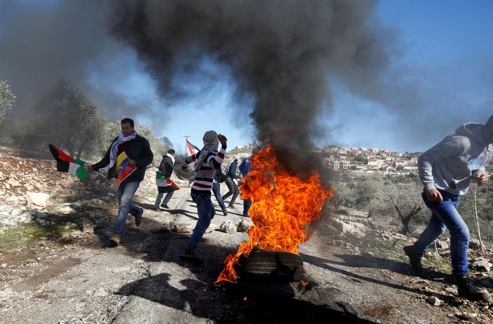 Palestinian protesters clash with Israeli troops in Qadomem, West Bank.