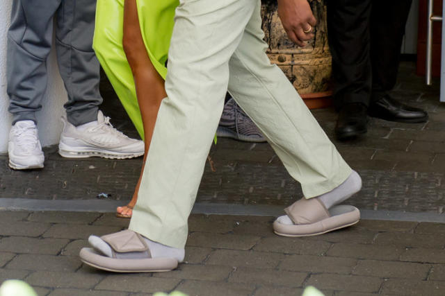 Kanye West rocks huge shoulder pads, sock shoes during outing with