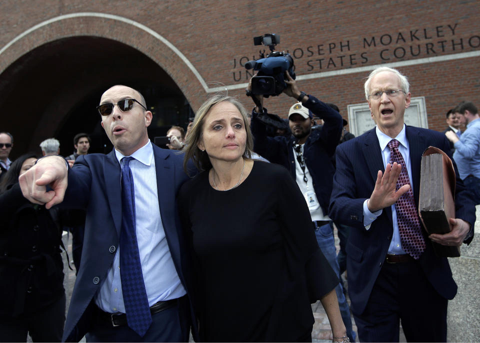 District Court Judge Shelley M. Richmond Joseph, center, departs federal court, Thursday, April 25, 2019, in Boston after facing obstruction of justice charges for allegedly helping a man in the country illegally evade immigration officials as he left her Newton, Mass., courthouse after a hearing in 2018. (AP Photo/Steven Senne)