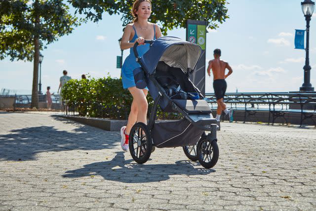 <p>Verywell Family / Jessica Juliao</p> The author testing the UPPAbaby Ridge jogging stroller on a sidewalk in New York City.