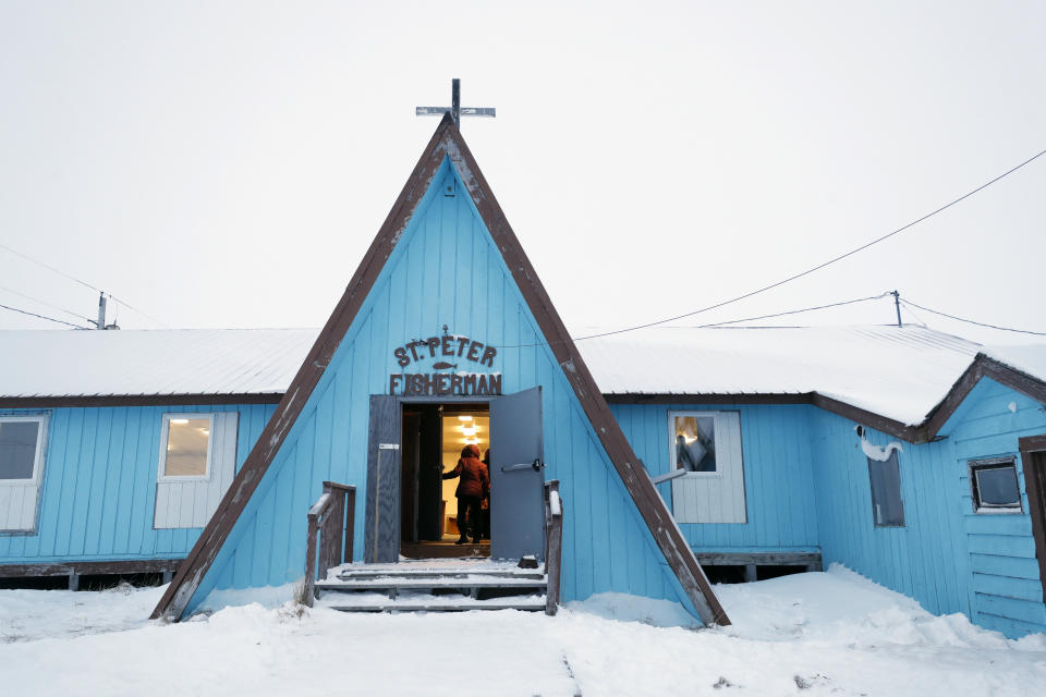 A woman arrives for services at the St. Peter Fisherman Church, Sunday, Jan. 19, 2020, in Toksook Bay, Alaska. The first Americans to be counted in the 2020 Census starting Tuesday, Jan. 21, live in this Bering Sea coastal village. (AP Photo/Gregory Bull)