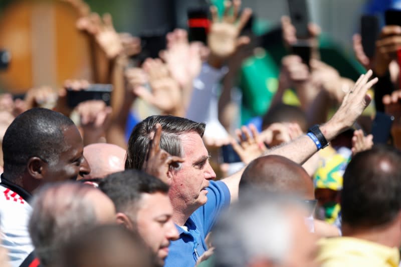 Brazil's President Jair Bolsonaro reacts during a meeting with supporters protesting in his favor, amid the coronavirus disease (COVID-19) outbreak, in Brasilia