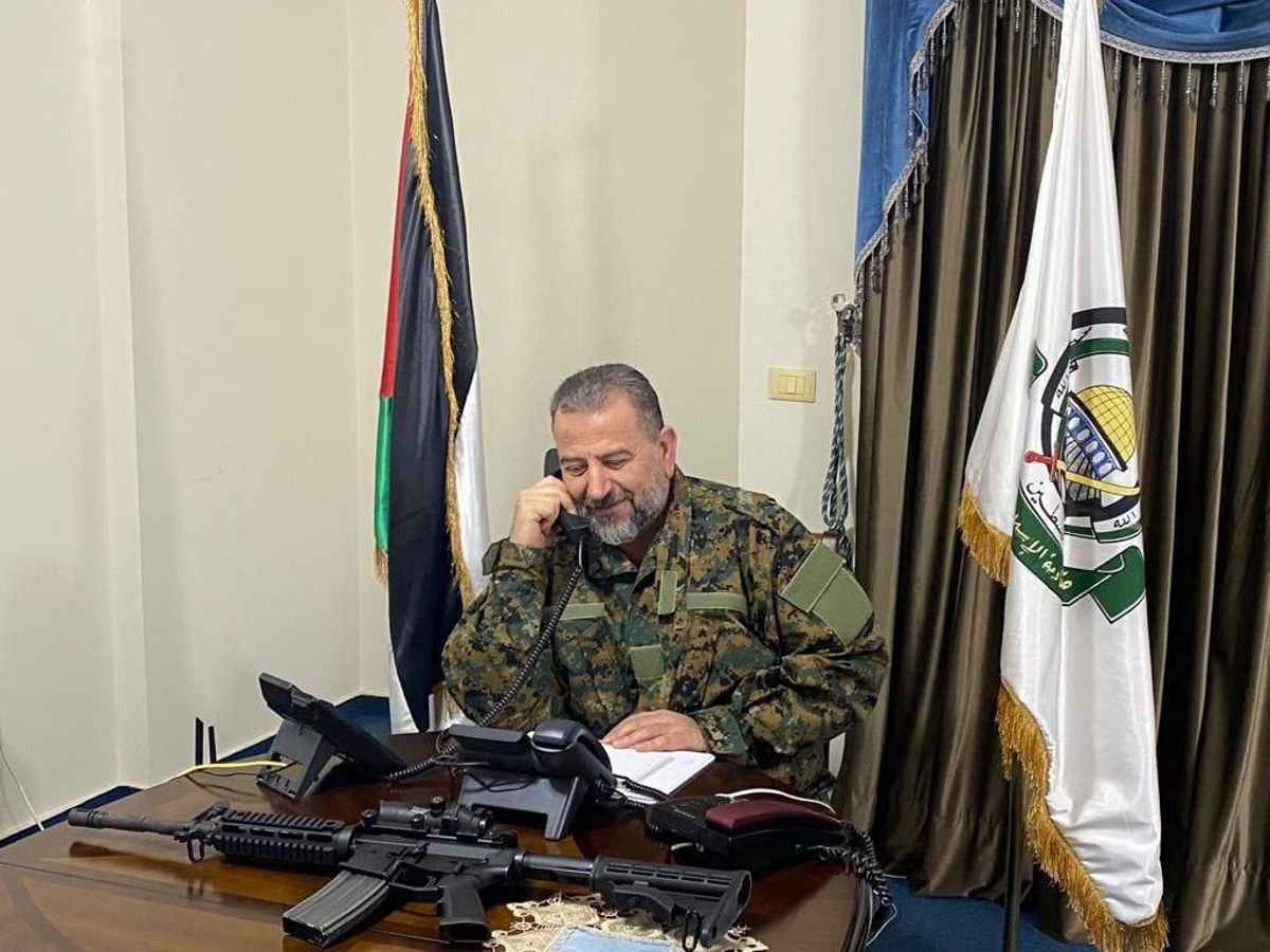 Sheikh Saleh al-Arouri in military camo alongside weapons (Hamas Media Office)