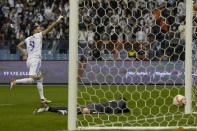 Real Madrid's Karim Benzema reacts after scoring from a penalty kick during the Spanish Super Cup final soccer match between Real Madrid and Athletic Bilbao at King Fahd stadium in Riyadh, Saudi Arabia, Sunday, Jan. 16, 2022. (AP Photo/Hassan Ammar)