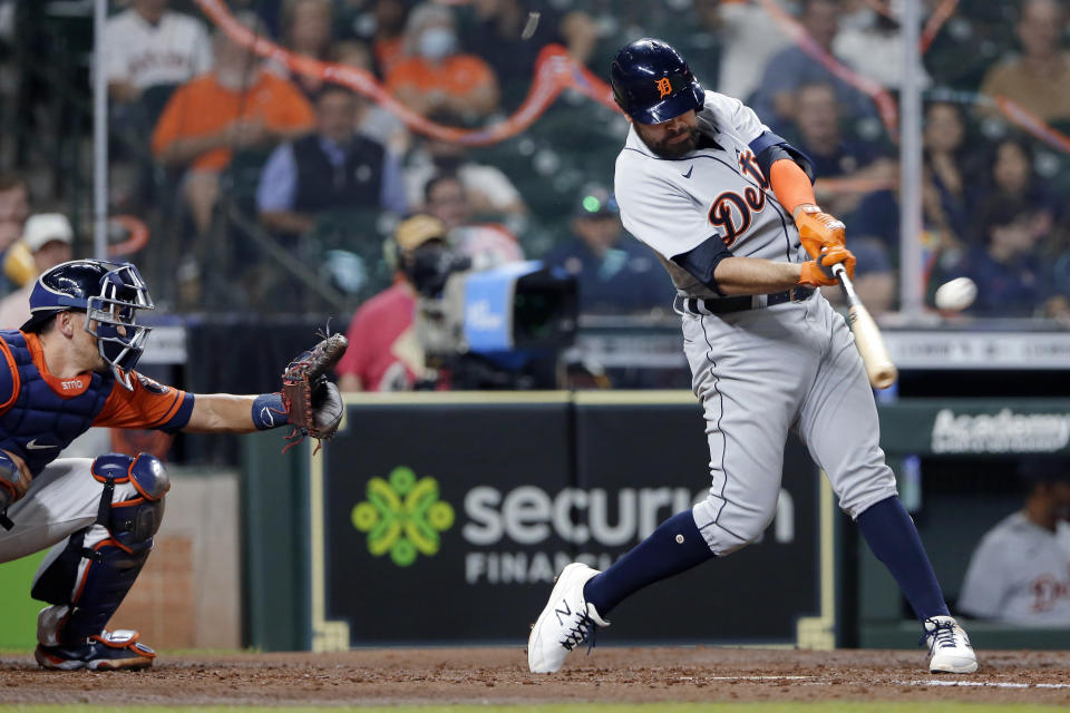 Detroit Tigers' Renato Nunez hits a two-run home run in front of Houston Astros catcher Jason Castro during the fourth inning of a baseball game Tuesday, April 13, 2021, in Houston. (AP Photo/Michael Wyke)