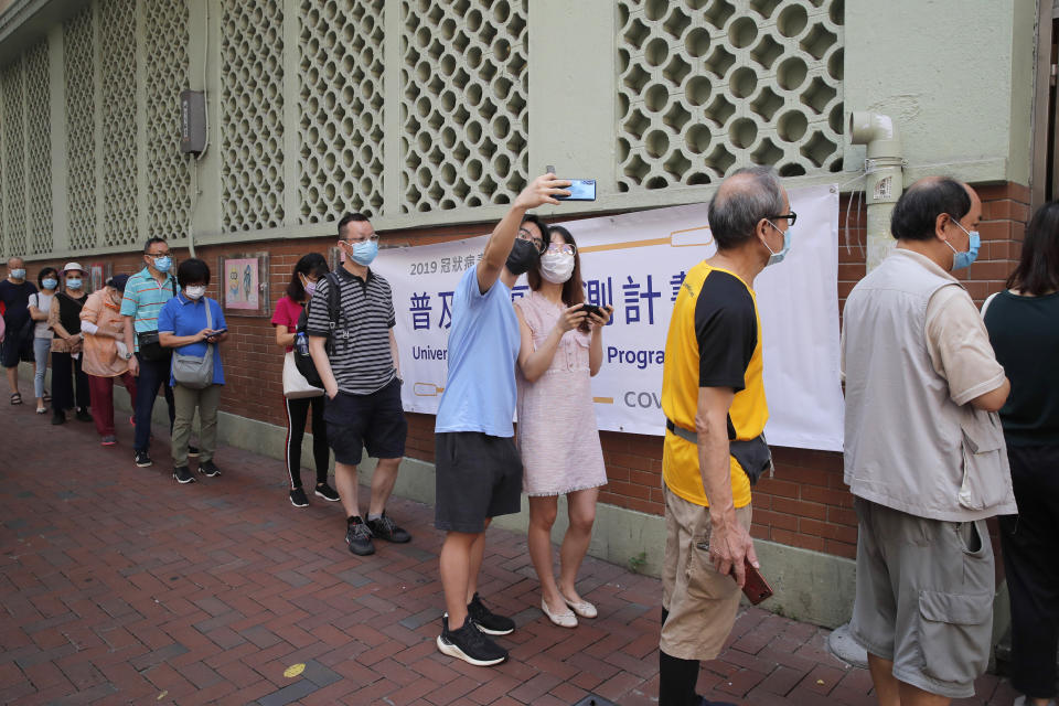 People wearing face masks queue for the coronavirus test outside a testing center in Hong Kong, Tuesday, Sept. 1, 2020. Hong Kong began a voluntary mass-testing program for coronavirus Tuesday as part of a strategy to break the chain of transmission in the city's third outbreak of the disease. The virus-testing program has become a flash point of political debate in Hong Kong, with many distrustful over resources and staff being provided by the China's central government and fears that the residents’ DNA could be collected during the exercise(AP Photo/Kin Cheung)