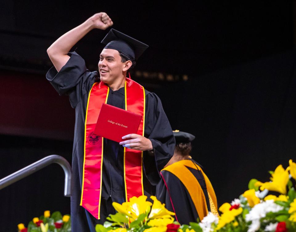 Alex Beltran pumps pumps his fist in the air after receiving his diploma during the 2024 College of the Desert Commencement ceremony at Acrisure Arena in Palm Desert, Calif., Tuesday, May 21, 2024.