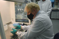 British Prime Minister Boris Johnson during a visit to The National Institute for Biological Standards, in South Mimms, England, Monday June 21, 2021. (Jeremy Selwyn/Pool via AP)