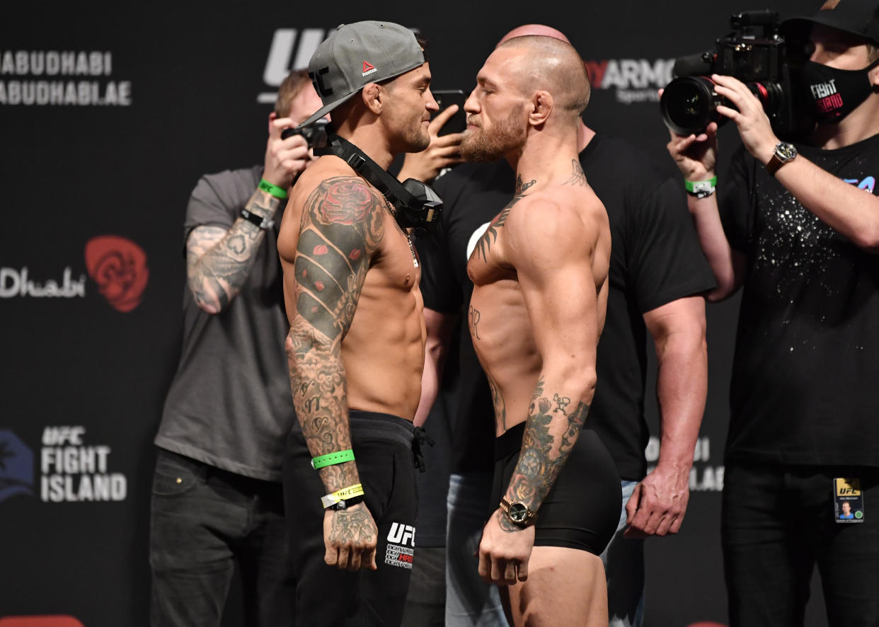 ABU DHABI, UNITED ARAB EMIRATES - JANUARY 22:  In this handout image provided by the UFC, (L-R) Opponents Dustin Poirier and Conor McGregor of Ireland face off during the UFC 257 weigh-in at Etihad Arena on UFC Fight Island on January 22, 2021 in Abu Dhabi, United Arab Emirates. (Photo by Jeff Bottari/Zuffa LLC via Getty Images)
