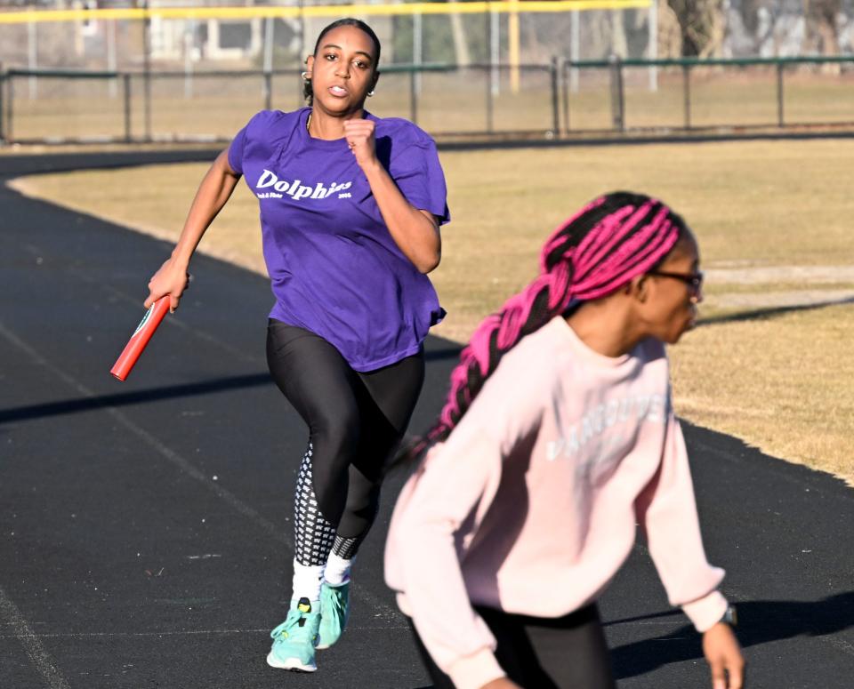 D-Y girls track runner Breanna Braham approaches to deliver the baton to Rose-Anna Joachim.