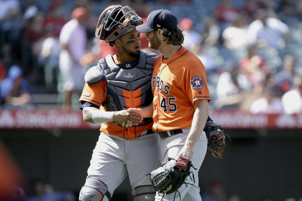 Houston Astros catcher Martin Maldonado, left, congratulates starting pitcher Gerrit Cole after the fifth inning of a baseball game against the Los Angeles Angels in Anaheim, Calif., Sunday, Sept. 29, 2019. (AP Photo/Alex Gallardo)
