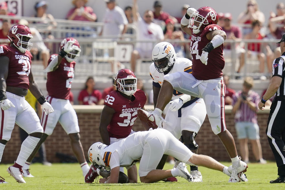 Oklahoma defensive lineman Reggie Grimes (14) celebrates after sacking UTEP quarterback Gavin Hardison, bottom, in the first half of an NCAA college football game, Saturday, Sept. 3, 2022, in Norman, Okla. (AP Photo/Sue Ogrocki)