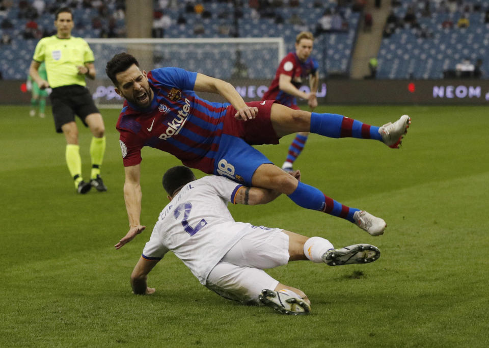 Soccer Football - Spanish Super Cup - Semi Final - Real Madrid v FC Barcelona - King Fahd International Stadium, Riyadh, Saudia Arabia - January 12, 2022 Real Madrid's Dani Carvajal in action with FC Barcelona's Jordi Alba REUTERS/Albert Gea