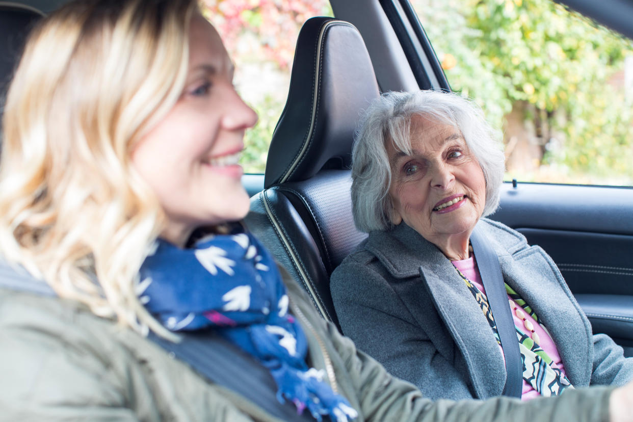 Female Neighbor Giving Senior Woman A Lift In Car